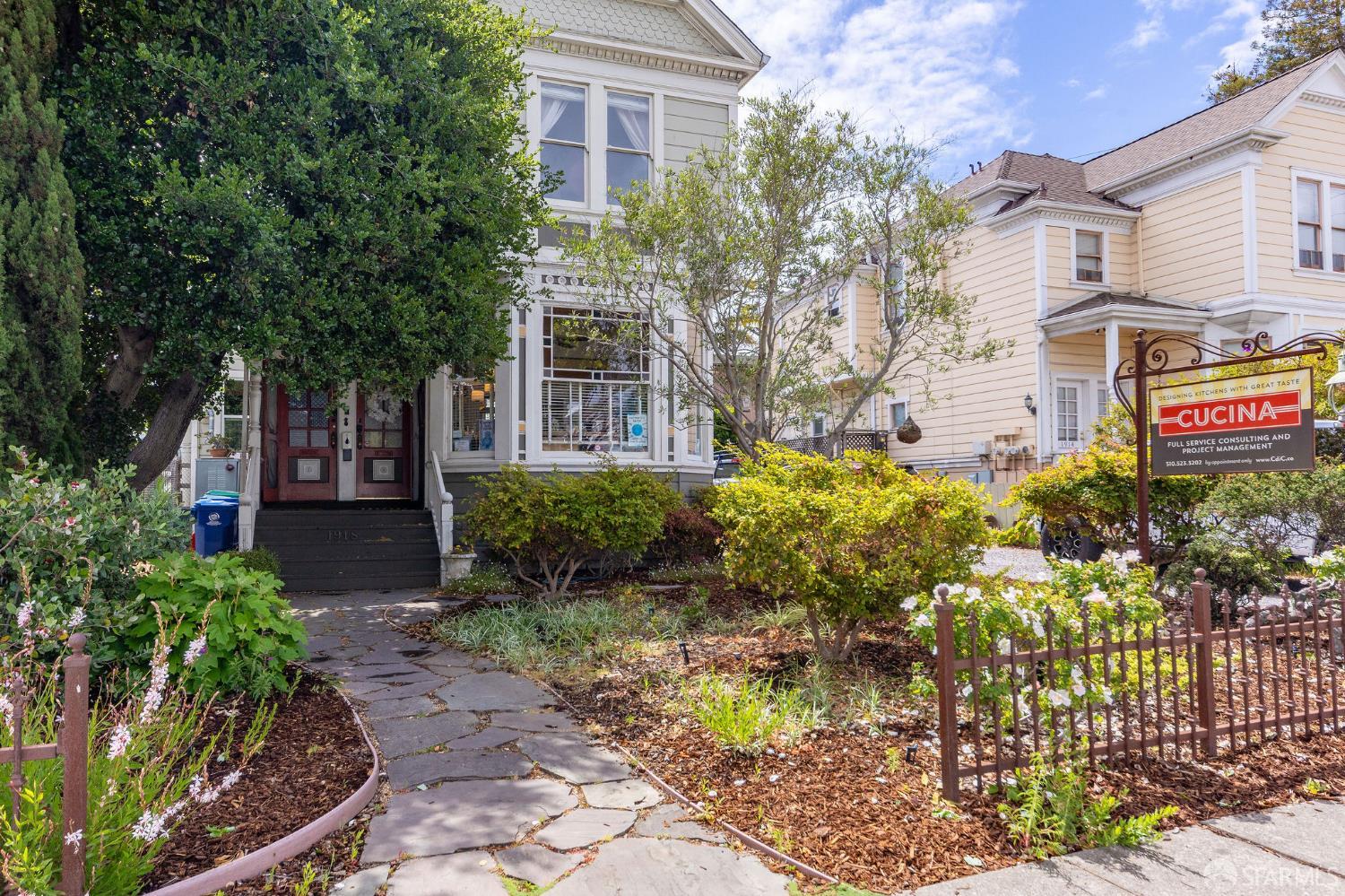 a front view of a house with a yard and flowers