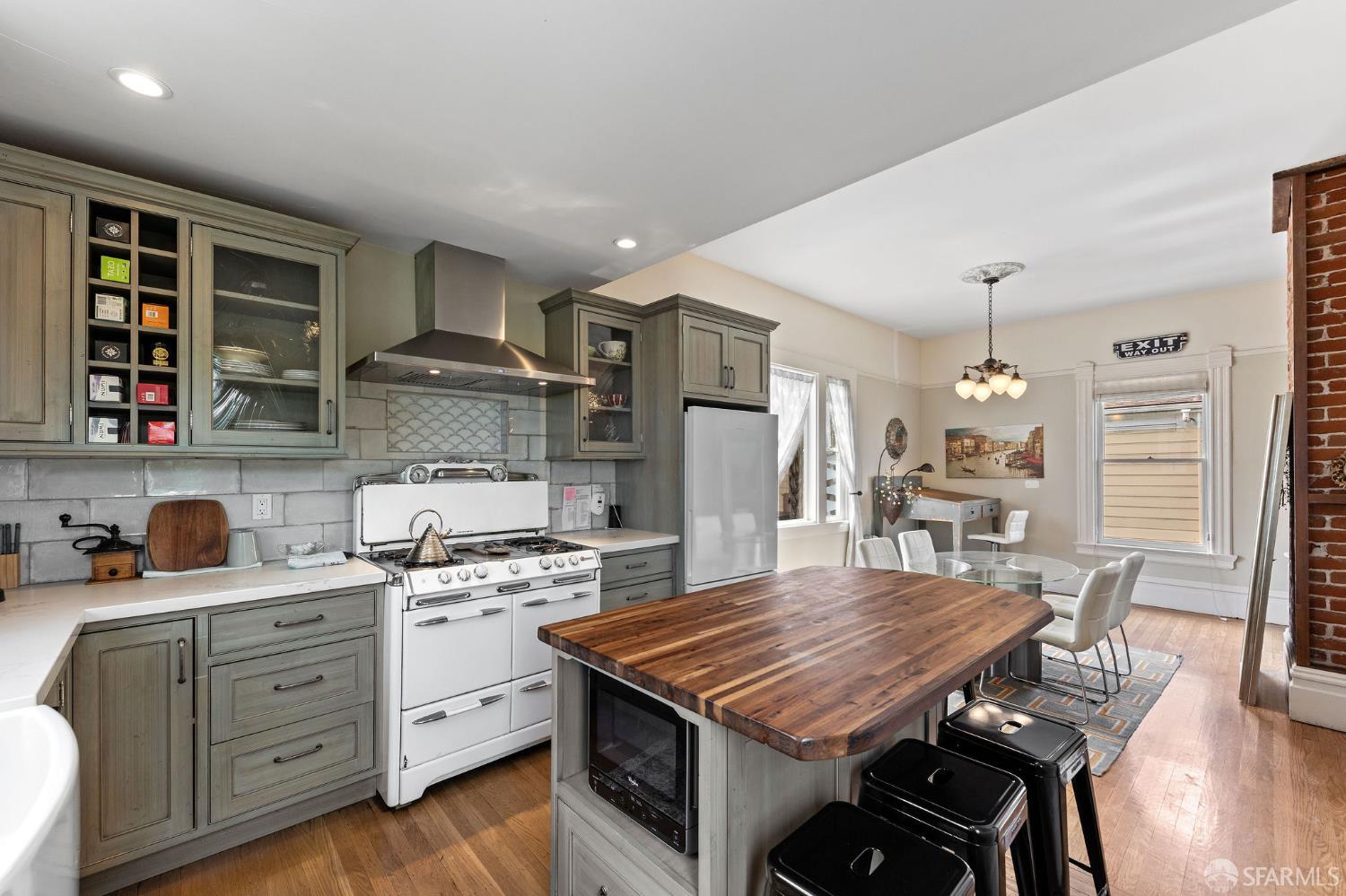 1918 Broadway Alameda, CA 94501 - Photo 19 of 28 a kitchen with a table chairs refrigerator and cabinets