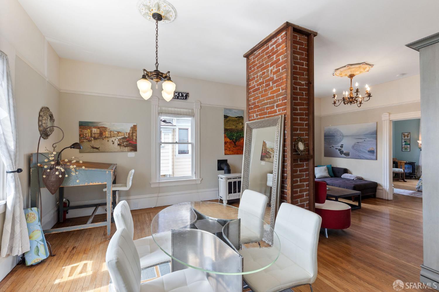 1918 Broadway Alameda, CA 94501 - Photo 20 of 28 a dining room with wooden floor a chandelier a glass table and chairs
