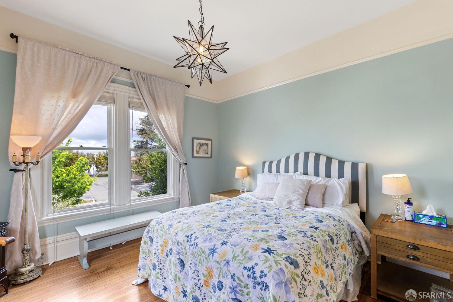 1918 Broadway Alameda, CA 94501 - Photo 22 of 28 a bedroom with a large bed and a chandelier