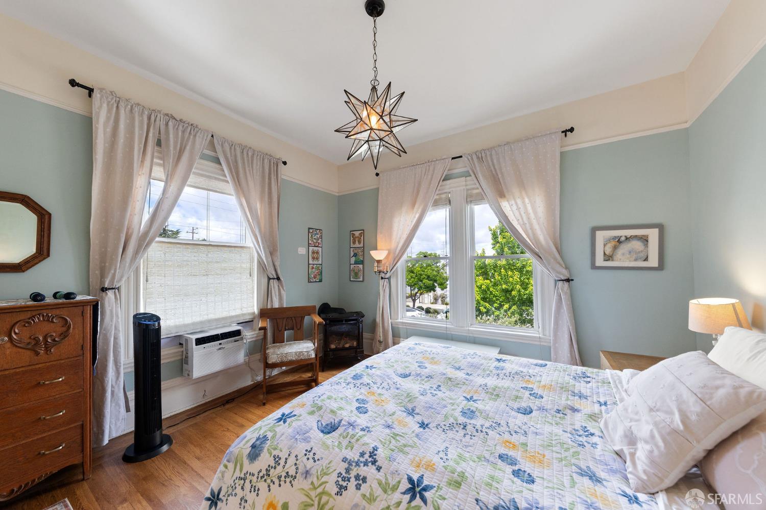 1918 Broadway Alameda, CA 94501 - Photo 23 of 28 a bedroom with a bed and a chandelier