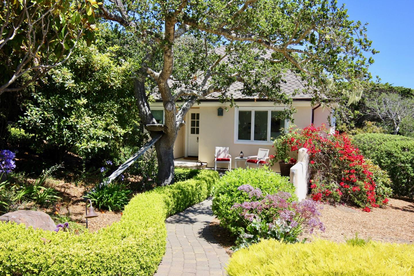 1465 Oleada Road Pebble Beach, CA 93953 - Photo 22 of 30 a view of a house with a yard and garden