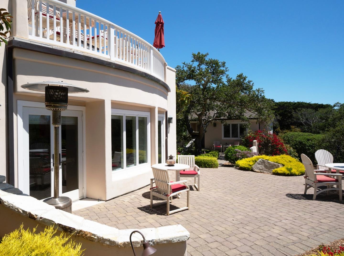 1465 Oleada Road Pebble Beach, CA 93953 - Photo 27 of 30 a view of a chair and tables in patio of the house