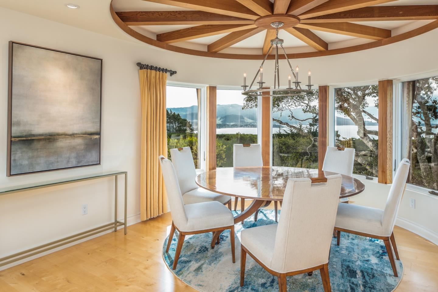 1465 Oleada Road Pebble Beach, CA 93953 - Photo 8 of 30 a dining room with furniture a chandelier and wooden floor