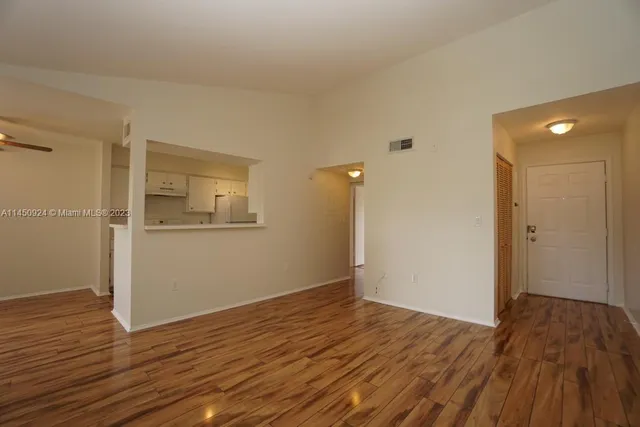 a view of a room with wooden floor and bathroom