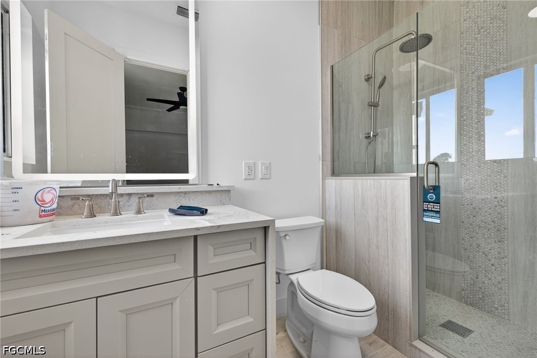 2665 Oil Well Road Naples, FL 34120 - Photo 22 of 40 a bathroom with a sink toilet and shower