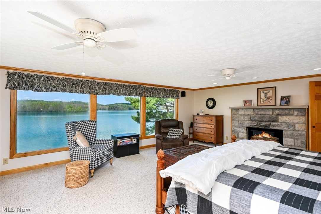 2873 Lodge Road Southwest Sherrodsville, OH 44675 - Photo 23 of 50 The spacious primary bedroom offers stunning lake views to wake up to. Only problem is...you may not want to get out of bed.
