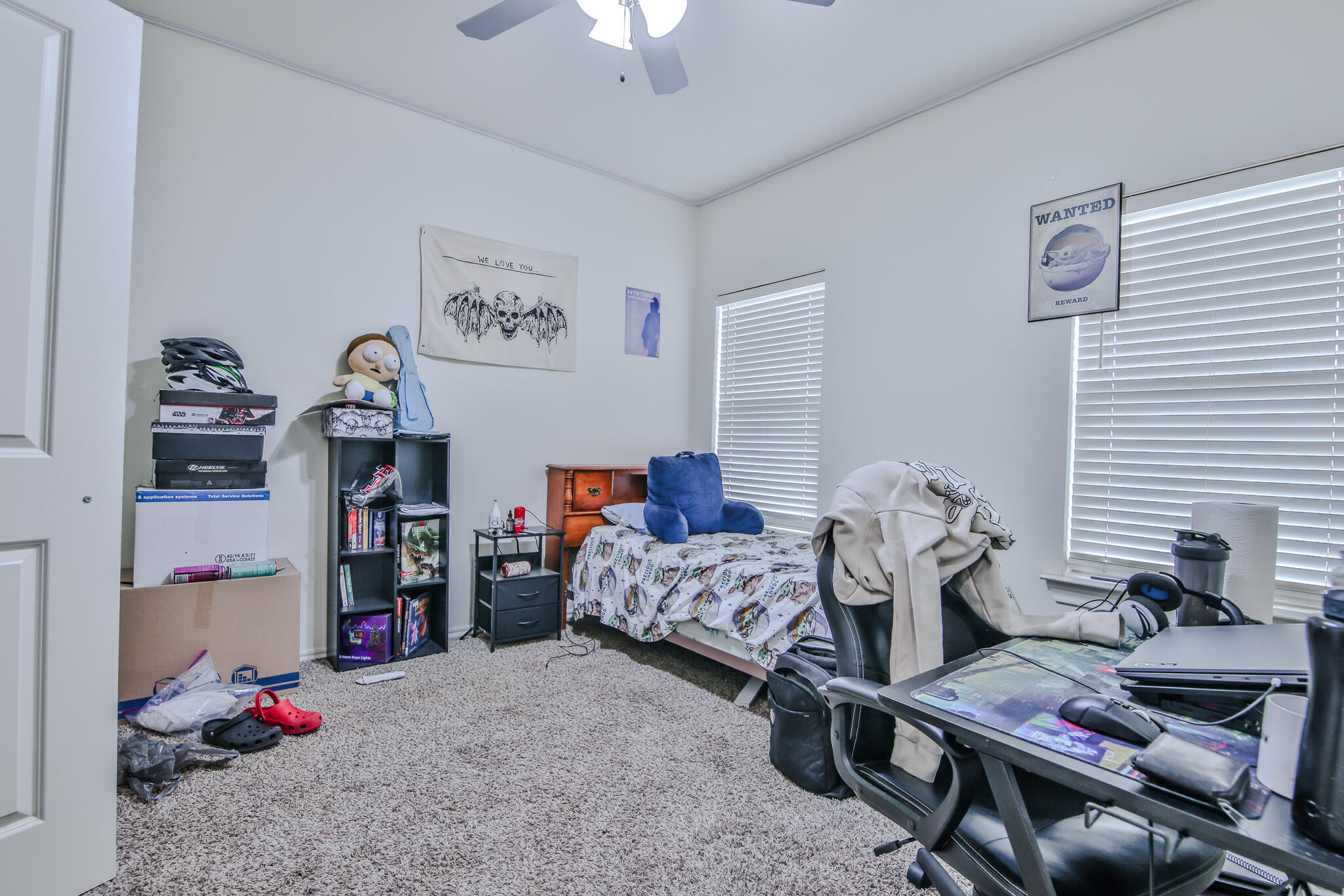 6902 20th Street Lubbock, TX 79407 - Photo 15 of 20 a bedroom with furniture and a chandelier fan