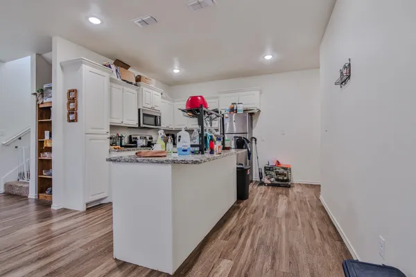 a kitchen with a refrigerator and a stove top oven