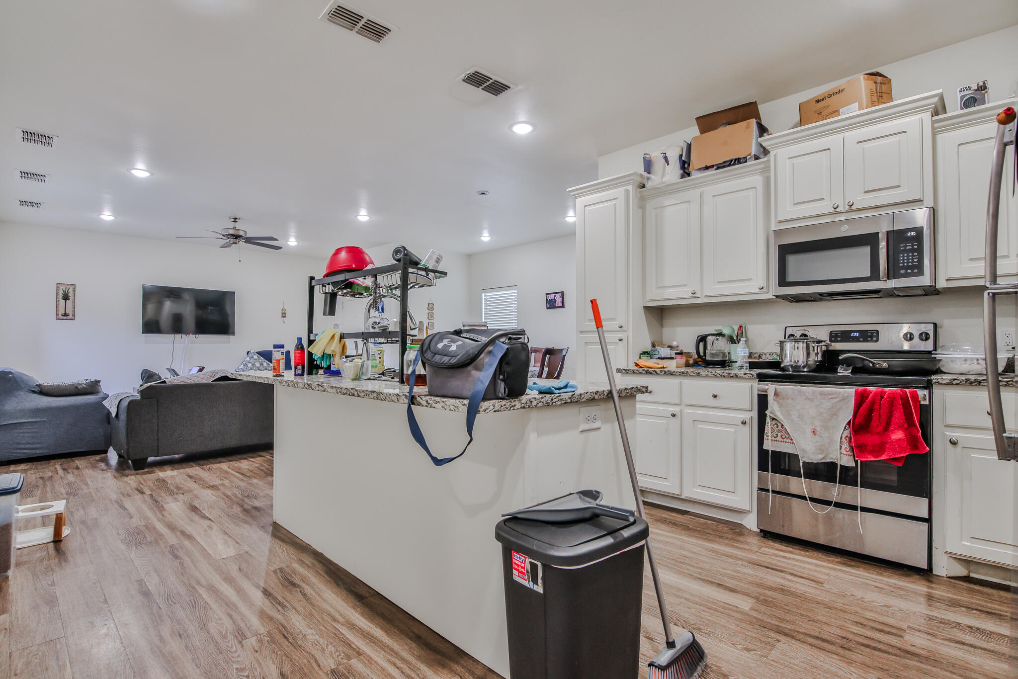 6902 20th Street Lubbock, TX 79407 - Photo 7 of 20 a kitchen with stainless steel appliances kitchen island granite countertop a stove and cabinets