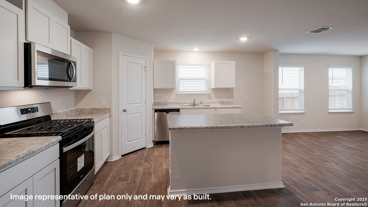 14790 Clay Rdg Run San Antonio, TX 78253 - Photo 4 of 28 a kitchen with stainless steel appliances granite countertop a stove a sink and a microwave
