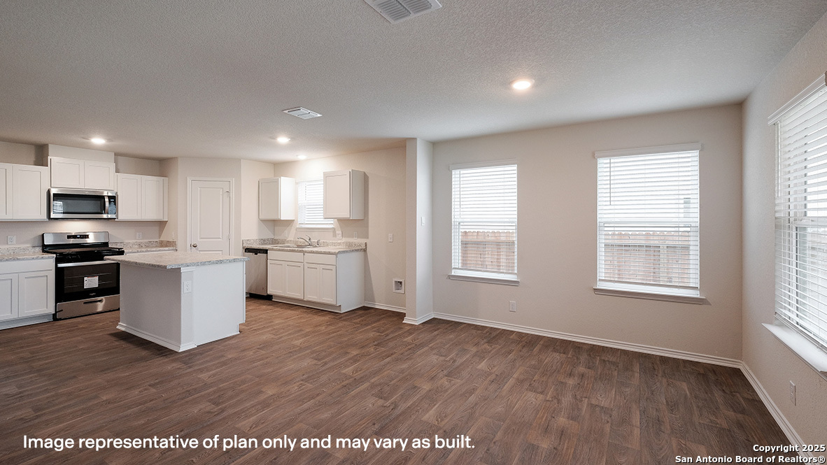 14790 Clay Rdg Run San Antonio, TX 78253 - Photo 8 of 28 a kitchen with granite countertop a stove a sink and a refrigerator
