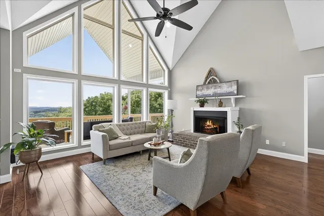 a spacious bedroom with a bed and large window with wooden floor