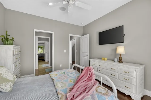 an empty room with furniture and a ceiling fan