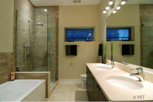 6 North May Street, Unit 201 Chicago, IL 60607 - Photo 6 of 10 a bathroom with a tub a sink and mirror