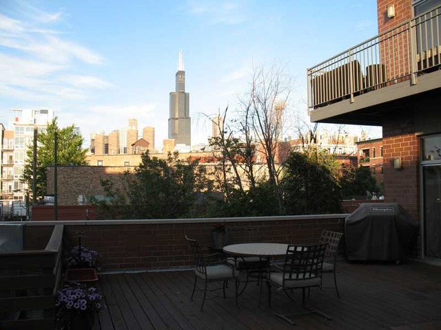 6 North May Street, Unit 201 Chicago, IL 60607 - Photo 9 of 10 a view of roof deck with chairs and wooden fence