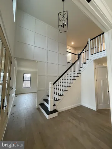 a view of entryway with stairs and wooden floor