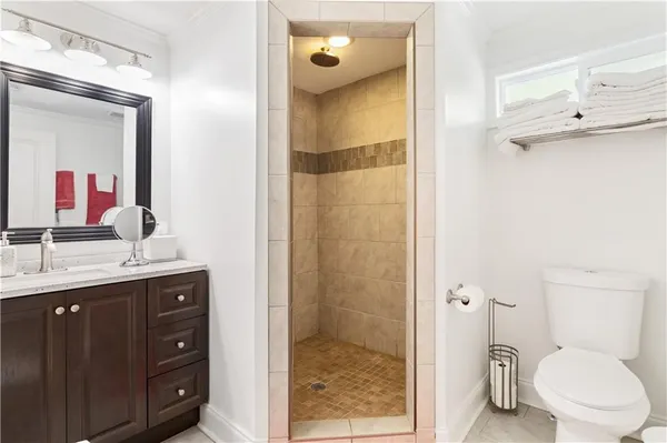 a bathroom with a granite countertop sink mirror and toilet