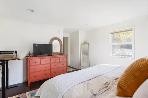 a bedroom with a bed and a flat screen tv