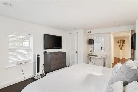 a bedroom with a bed and a flat screen tv in it