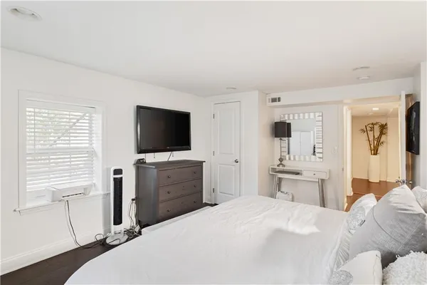 a bedroom with a bed and a flat screen tv in it
