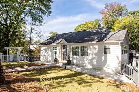 a view of a house with a tree in the background