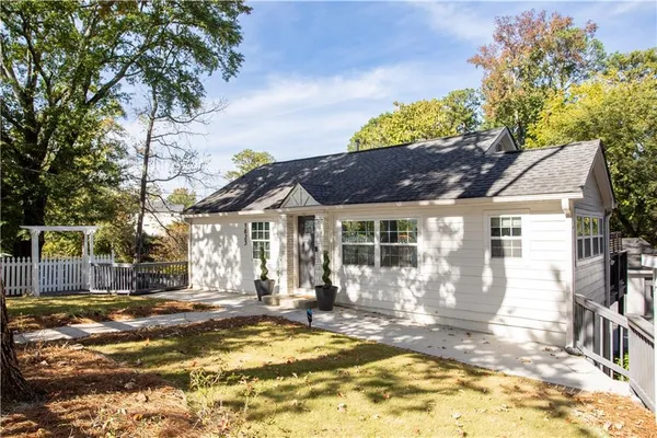 a view of a house with a tree in the background