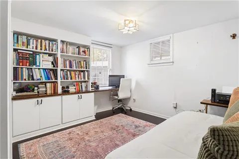 a room that has a bed and a bookshelf