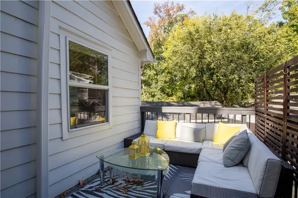 a balcony with furniture and wooden floor