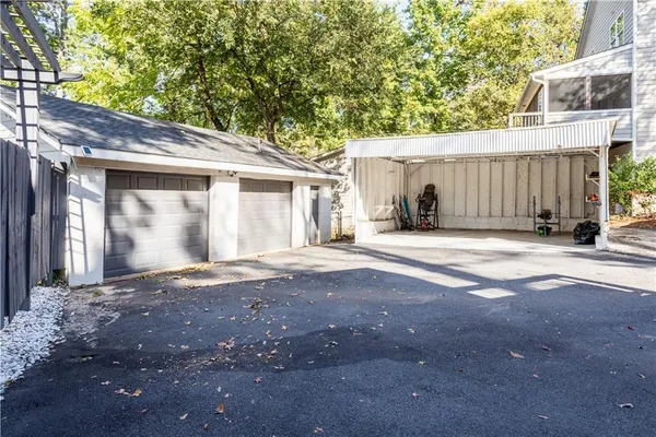 a view of a house with backyard and a tree