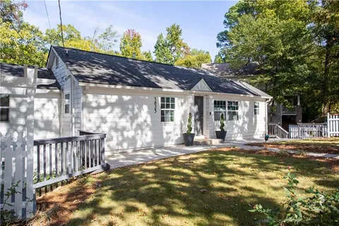 a view of a house with a small yard and wooden floor