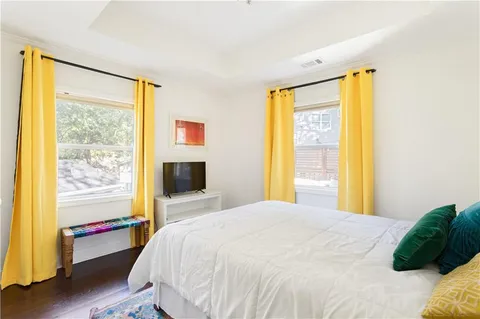 a bedroom with a bed and a large window