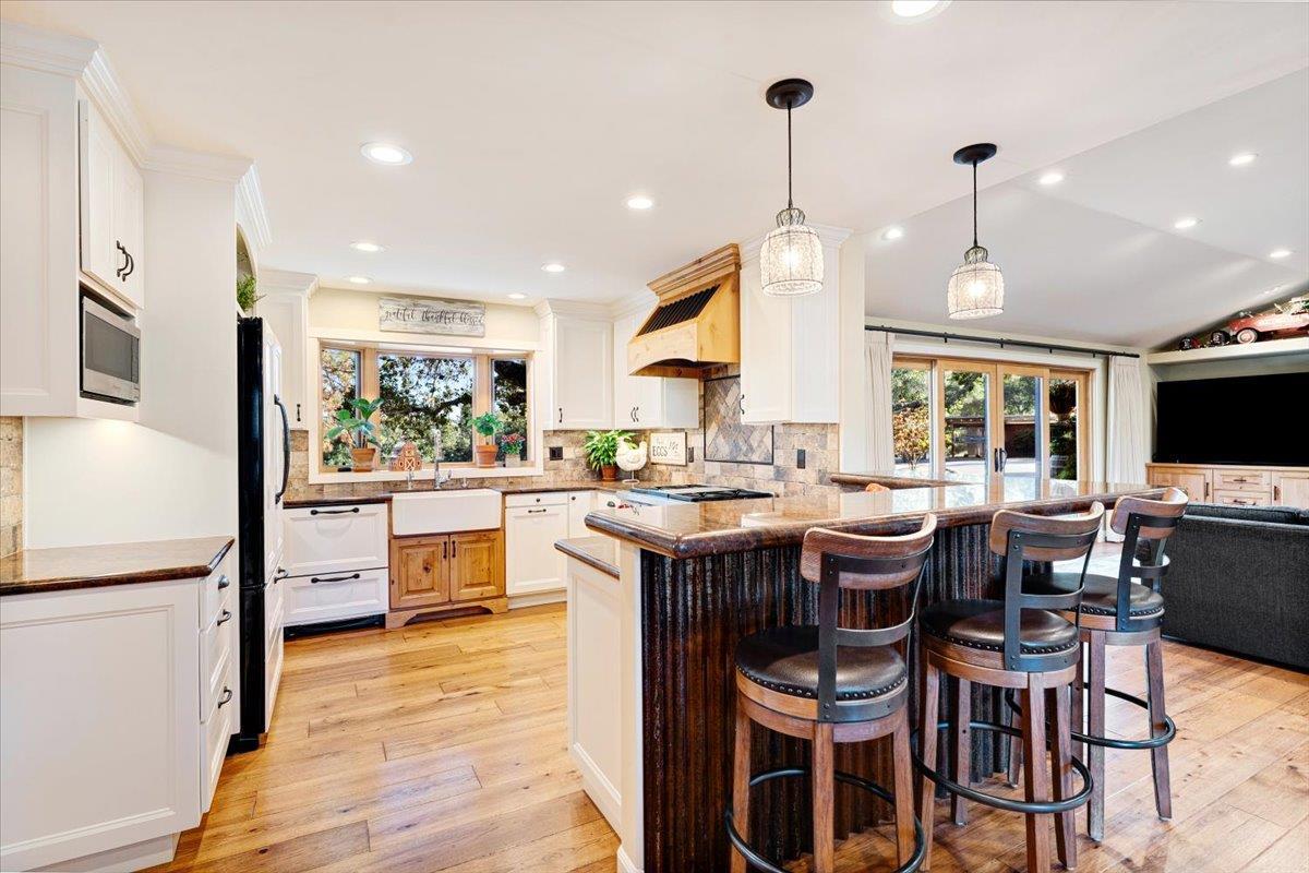 7409 Hihn Road Ben Lomond, CA 95005 - Photo 24 of 101 a kitchen that has a lot of cabinets in it and wooden floors
