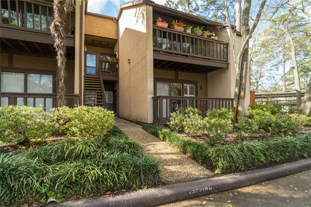 a front view of a house with a yard garage and outdoor seating