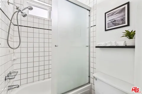 a bathroom with a shower and a toilet
