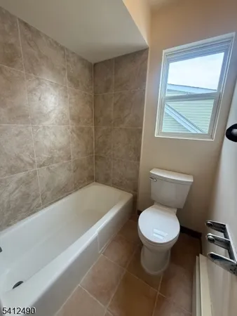 a bathroom with a toilet and a bathtub