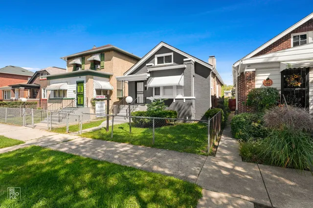 a front view of a house with a yard and porch