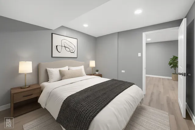 a bedroom with bed and a night stand