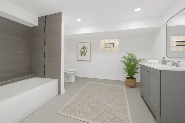 a bathroom with a bathtub a sink a toilet and a shower