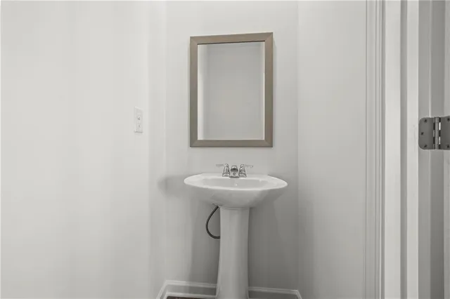 a bathroom with a sink a mirror and a