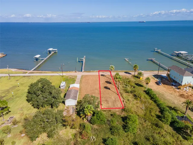 an aerial view of a house with a yard basket ball court