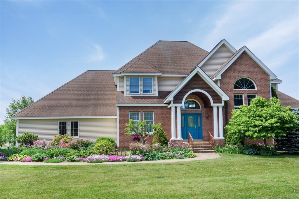 a front view of a house with a garden