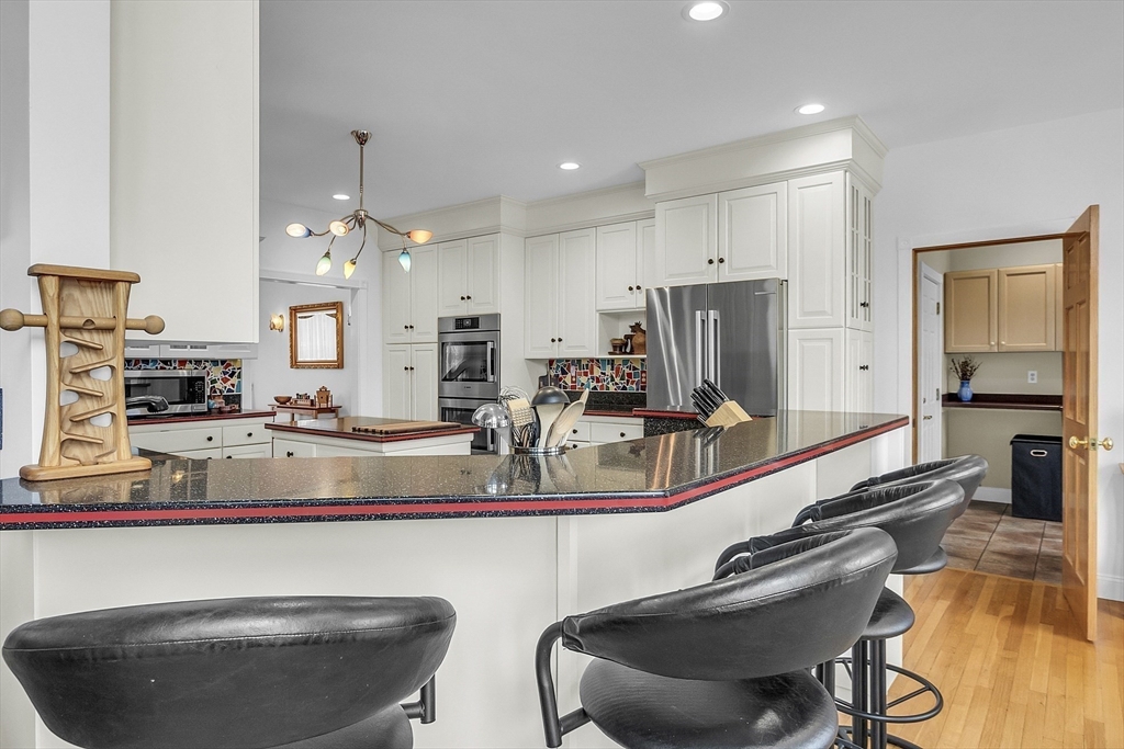 148 Houghton Road Princeton, MA 01541 - Photo 13 of 42 a view of a kitchen with kitchen island dining table and chairs