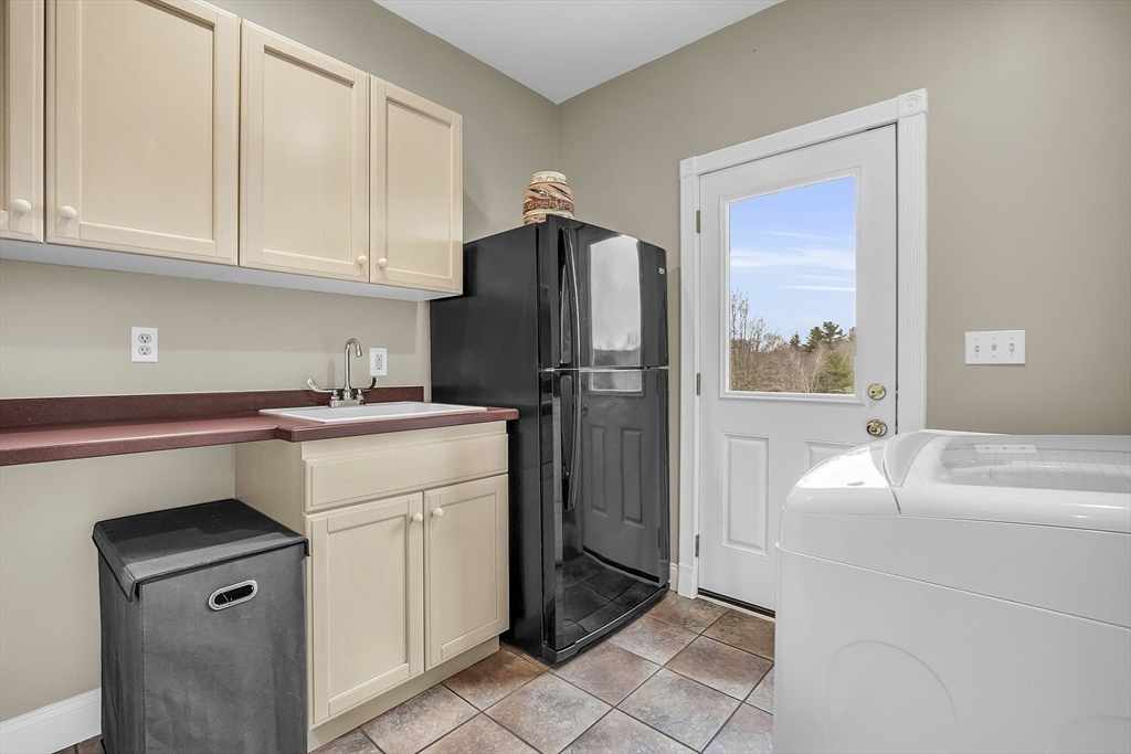 148 Houghton Road Princeton, MA 01541 - Photo 36 of 42 a kitchen with a refrigerator sink and cabinets