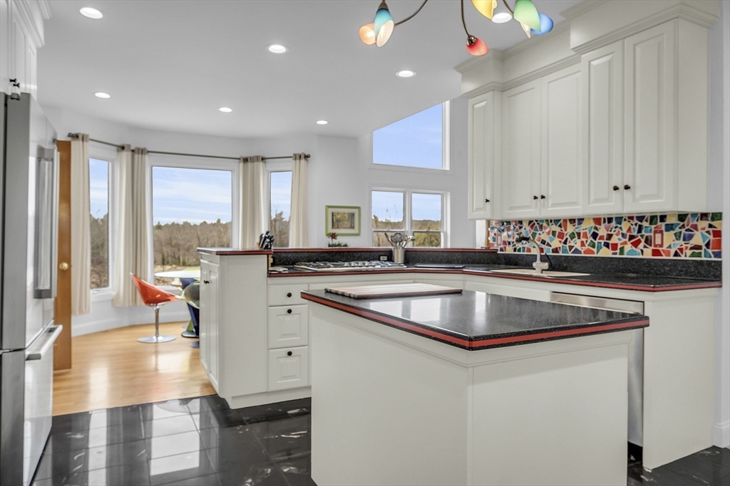 148 Houghton Road Princeton, MA 01541 - Photo 10 of 42 a kitchen with stainless steel appliances granite countertop a sink stove and cabinets