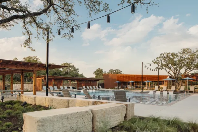 a view of a swimming pool with a patio and a yard