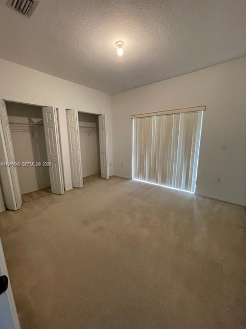 1941 Southeast 23rd Terrace, Unit 1941 Homestead, FL 33035 - Photo 7 of 7 an empty room with closet and natural light
