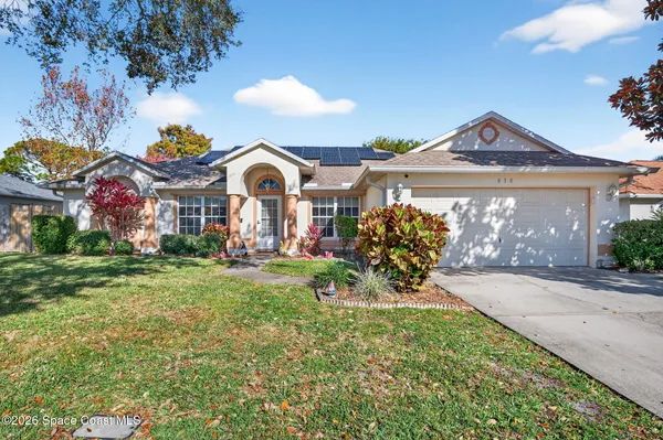 a view of a house with a yard and a garden