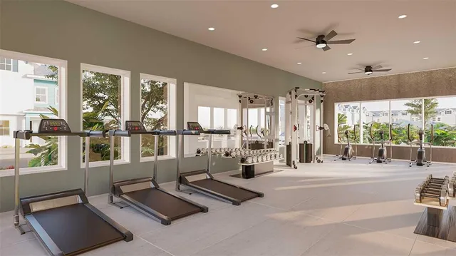 a living room with furniture gym equipment and large windows