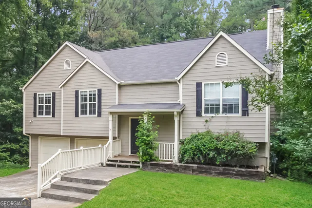 a view of a house with brick walls and a yard plants